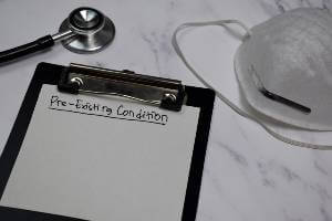 clipboard with preexisting condition written on it