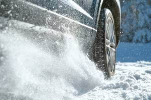 sedan driving through snow