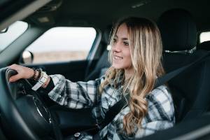 female driver smiling at the wheel