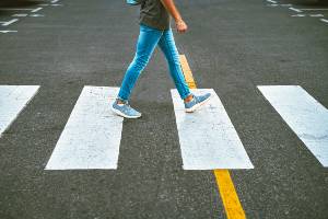 woman crossing empty street