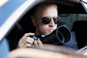 holding camera sitting in car