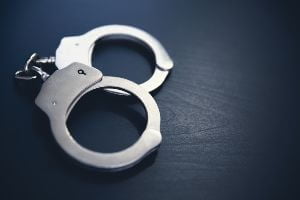 silver handcuffs on dark table