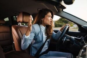 young female woman yelling while driving
