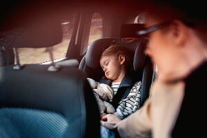 parent driver distracted by sleeping child
