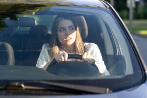 young female driver looking timid