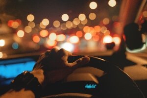 driver looking at a highway full of headlights at night