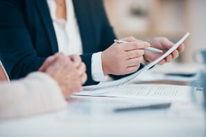 stock image of attorney reviewing documents with client