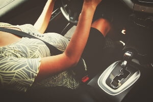 image of pregnant woman strapped in seat belt in driver's seat