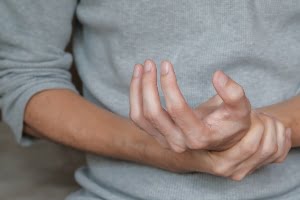 grabbing wrist in pain