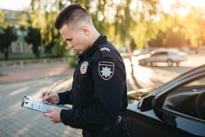 Young officer documenting a crash scene