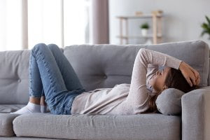 exhausted person laying on couch