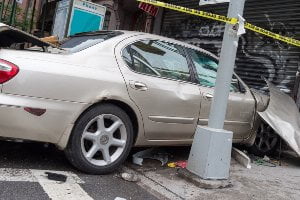 car crash with building on sidewalk