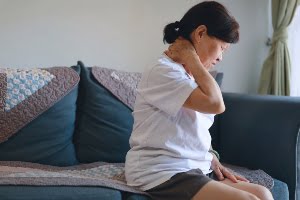 A woman with neck pain.