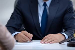 lawyer meeting with client and taking notes