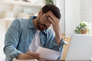 man concerned about letter he is reading