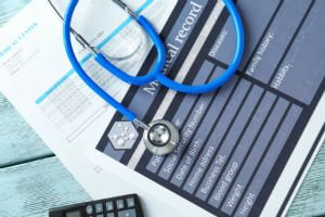 stethoscope on top of medical records