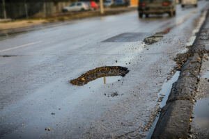 road with potholes on the side