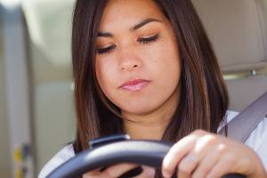 teenager on phone while behind wheel